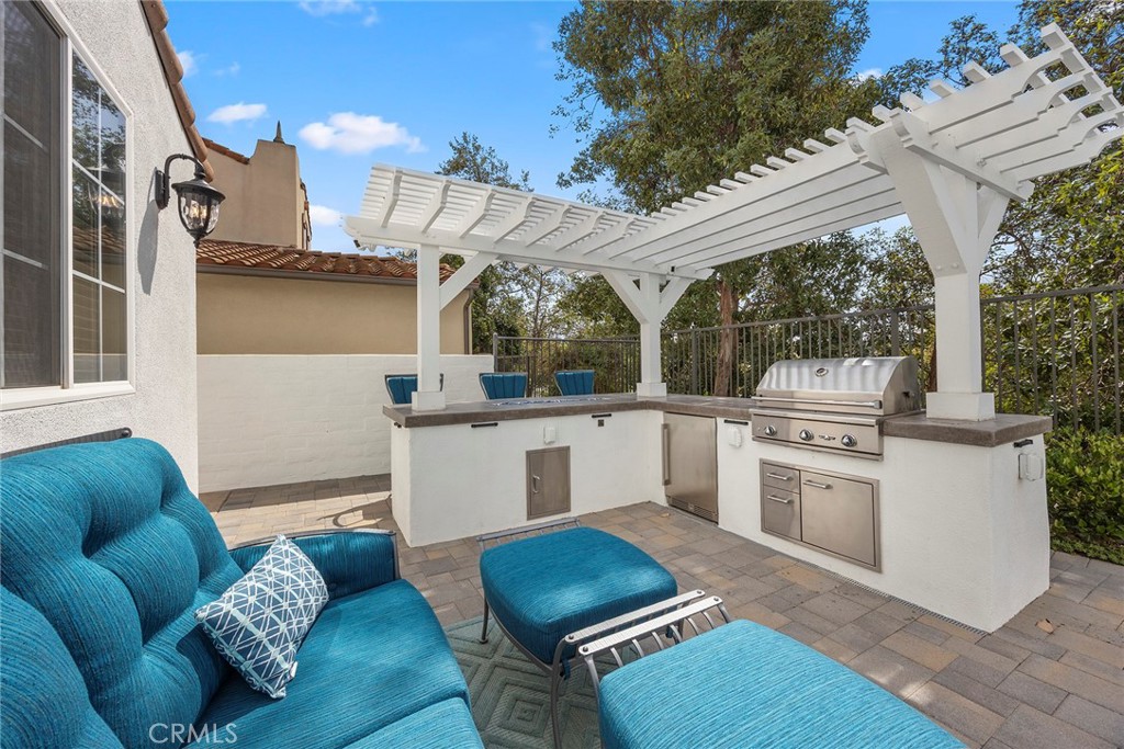 16 Kempton Lane Ladera Ranch, CA 92694 - Photo 52 of 60 Recently constructed BBQ island with lattice cover, refrigerator, and fire feature.