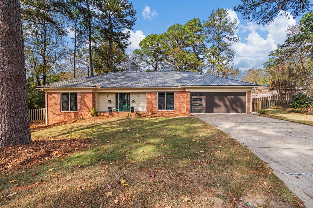 a front view of a house with a garden