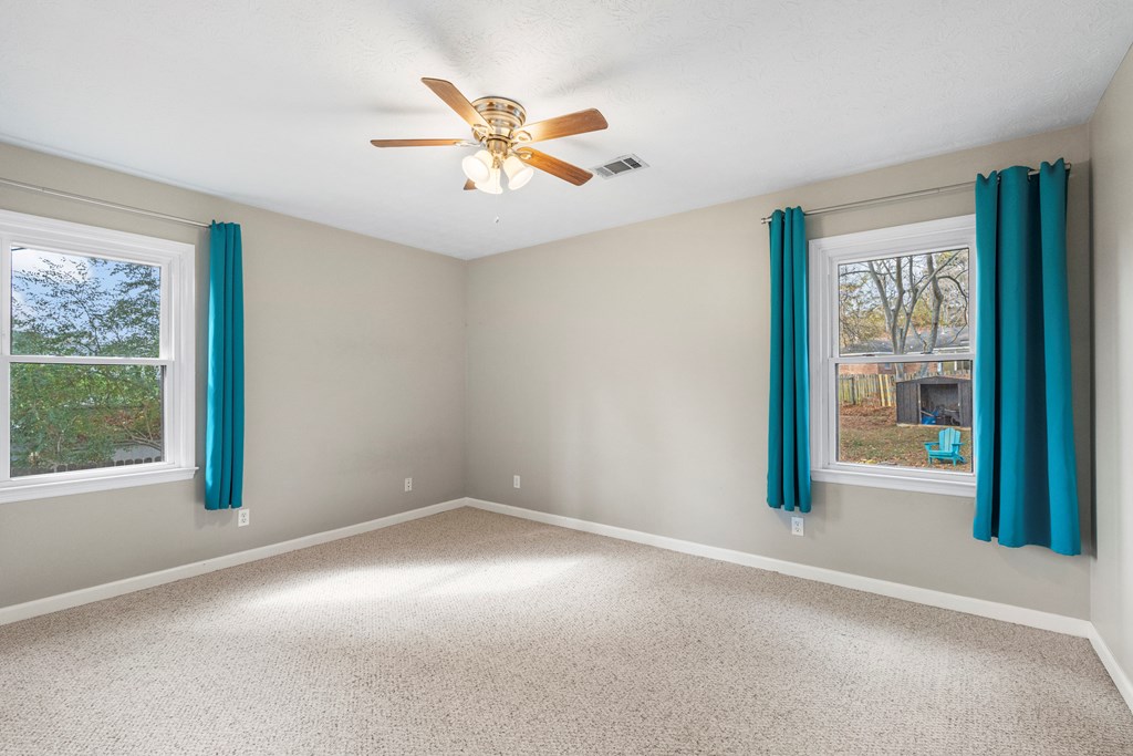 3 Panstone Court Columbus, GA 31909 - Photo 11 of 24 an empty room with windows and fan
