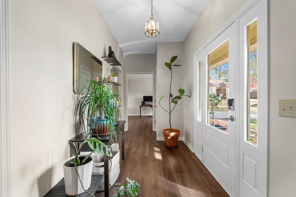 3 Panstone Court Columbus, GA 31909 - Photo 3 of 24 a hallway with a potted plant on the floor and a view of living room