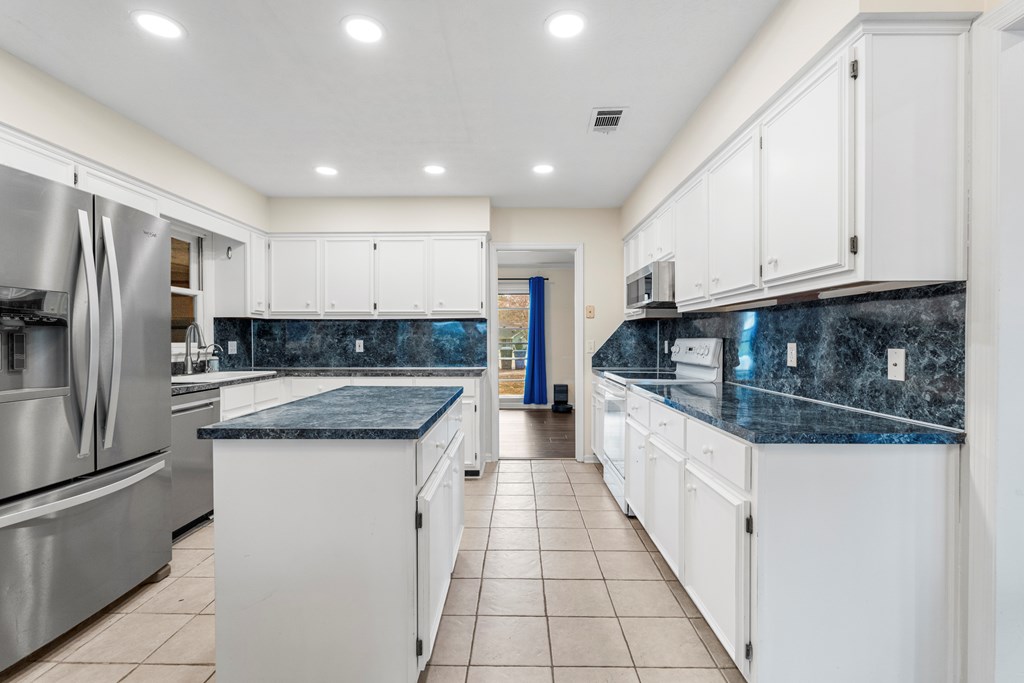 3 Panstone Court Columbus, GA 31909 - Photo 7 of 24 a large kitchen with stainless steel appliances granite countertop a stove and a refrigerator