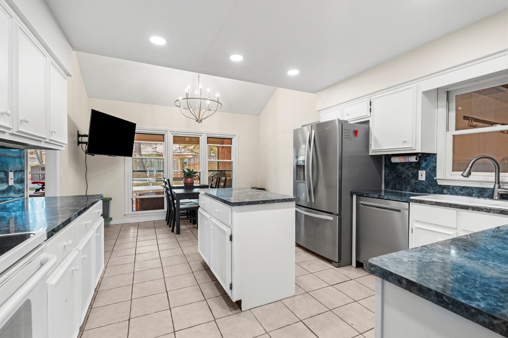 3 Panstone Court Columbus, GA 31909 - Photo 8 of 24 a kitchen with granite countertop a refrigerator stove top oven and sink