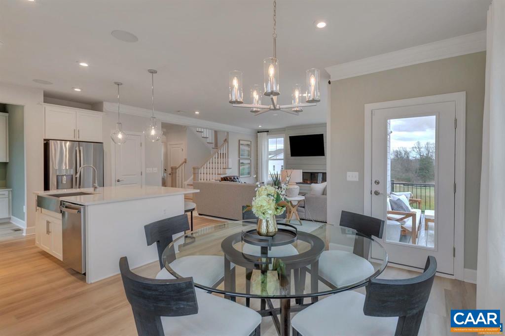 2837 Rambling Brook Lane Crozet, VA 22932 - Photo 10 of 24 a view of a dining room with furniture a kitchen and chandelier