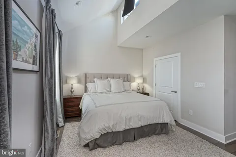 a bedroom with a bed and night stand