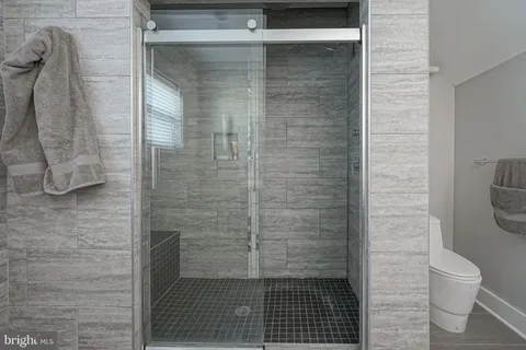 a bathroom with a toilet and a shower