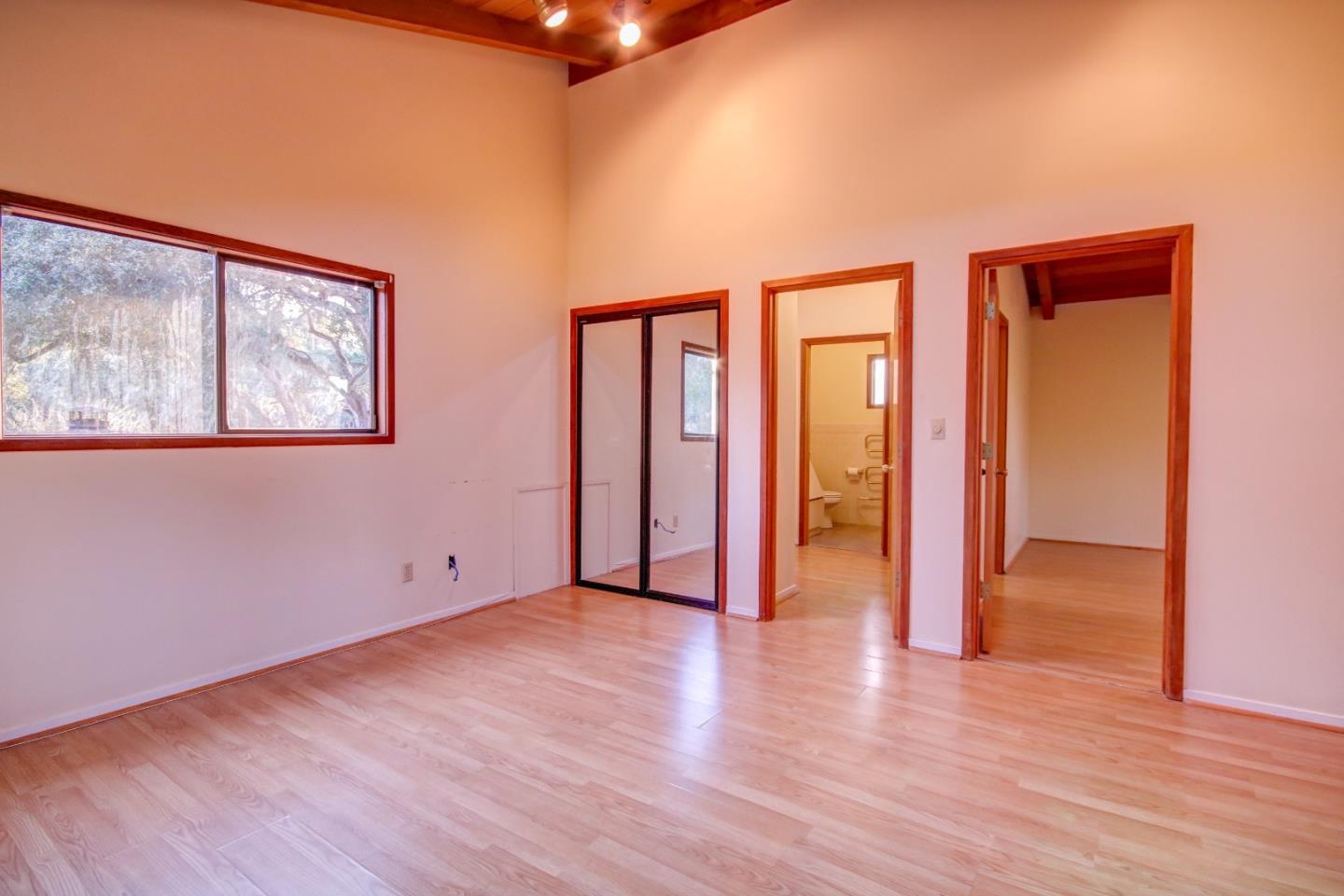 816 Gate Street Pacific Grove, CA 93950 - Photo 13 of 18 a view of an empty room with wooden floor and a window