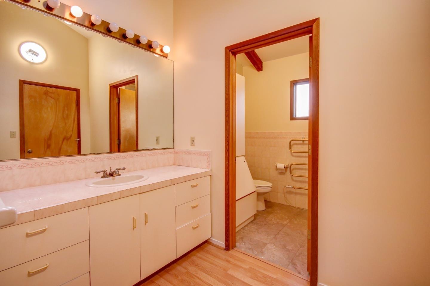 816 Gate Street Pacific Grove, CA 93950 - Photo 15 of 18 a en suite bathroom with a granite countertop sink toilet and shower