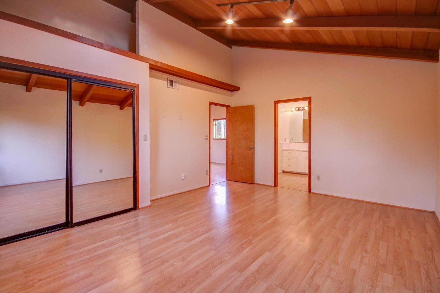 816 Gate Street Pacific Grove, CA 93950 - Photo 16 of 18 a view of an empty room with wooden floor and a window