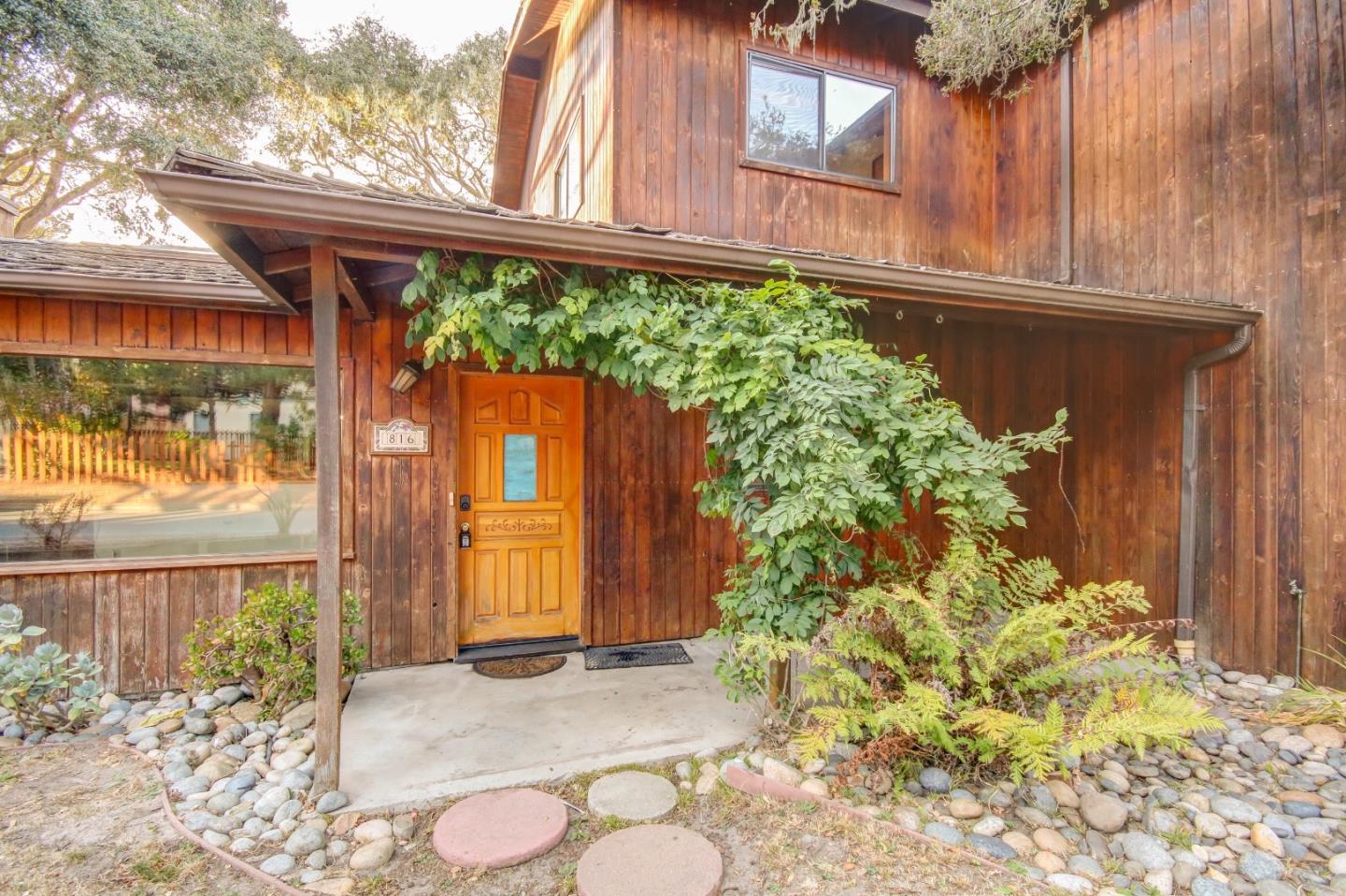 816 Gate Street Pacific Grove, CA 93950 - Photo 2 of 18 a backyard of a house with a garden and pathway