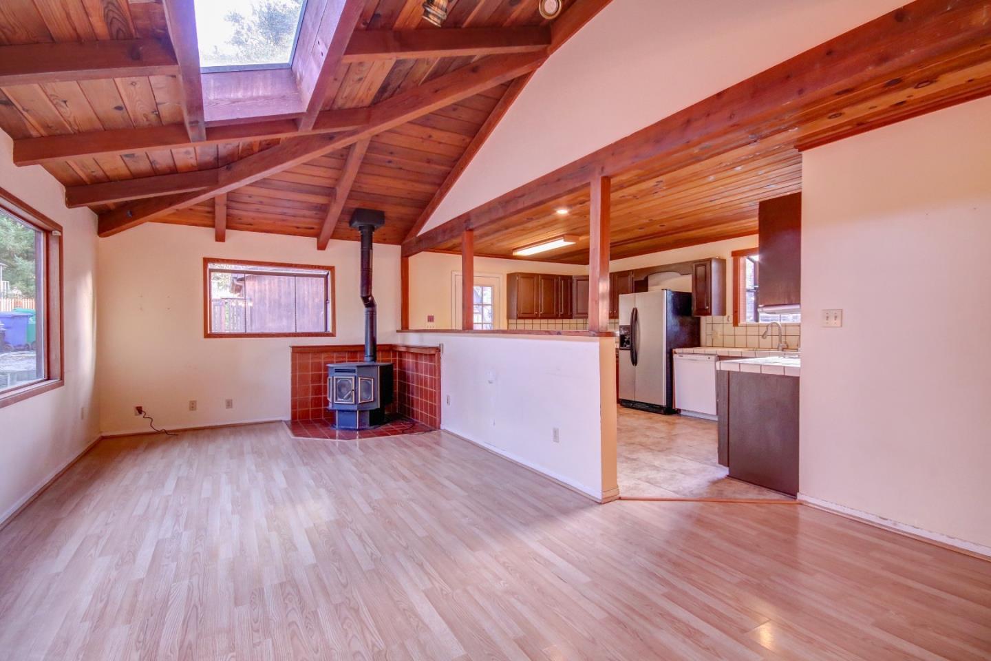 816 Gate Street Pacific Grove, CA 93950 - Photo 3 of 18 a view of a room with wooden floor and a kitchen