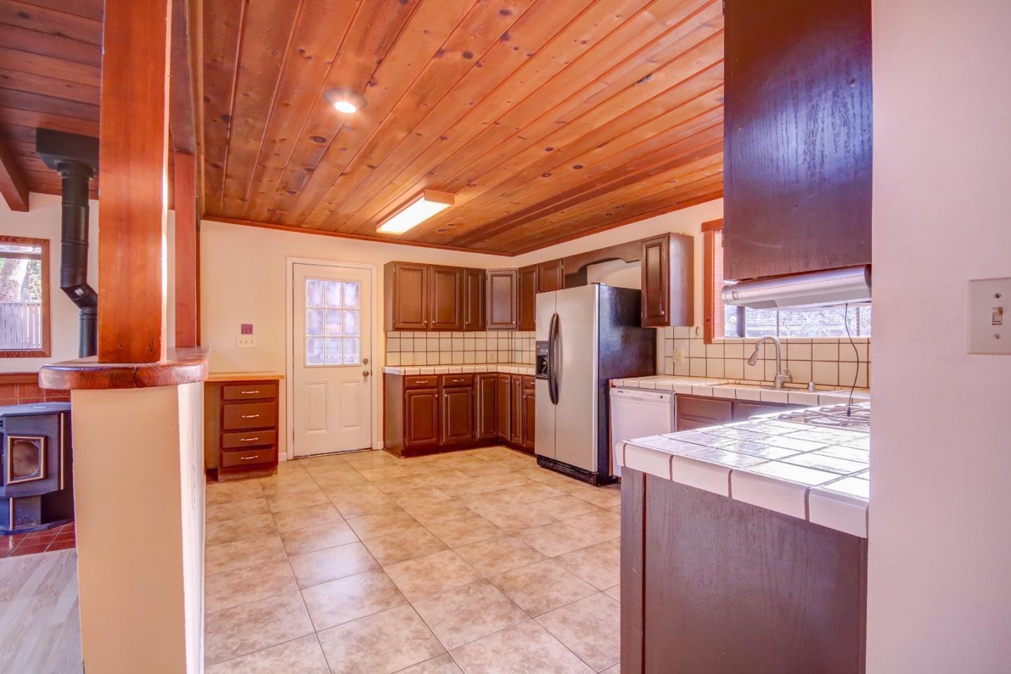 816 Gate Street Pacific Grove, CA 93950 - Photo 6 of 18 a kitchen with stainless steel appliances granite countertop a refrigerator and a stove top oven