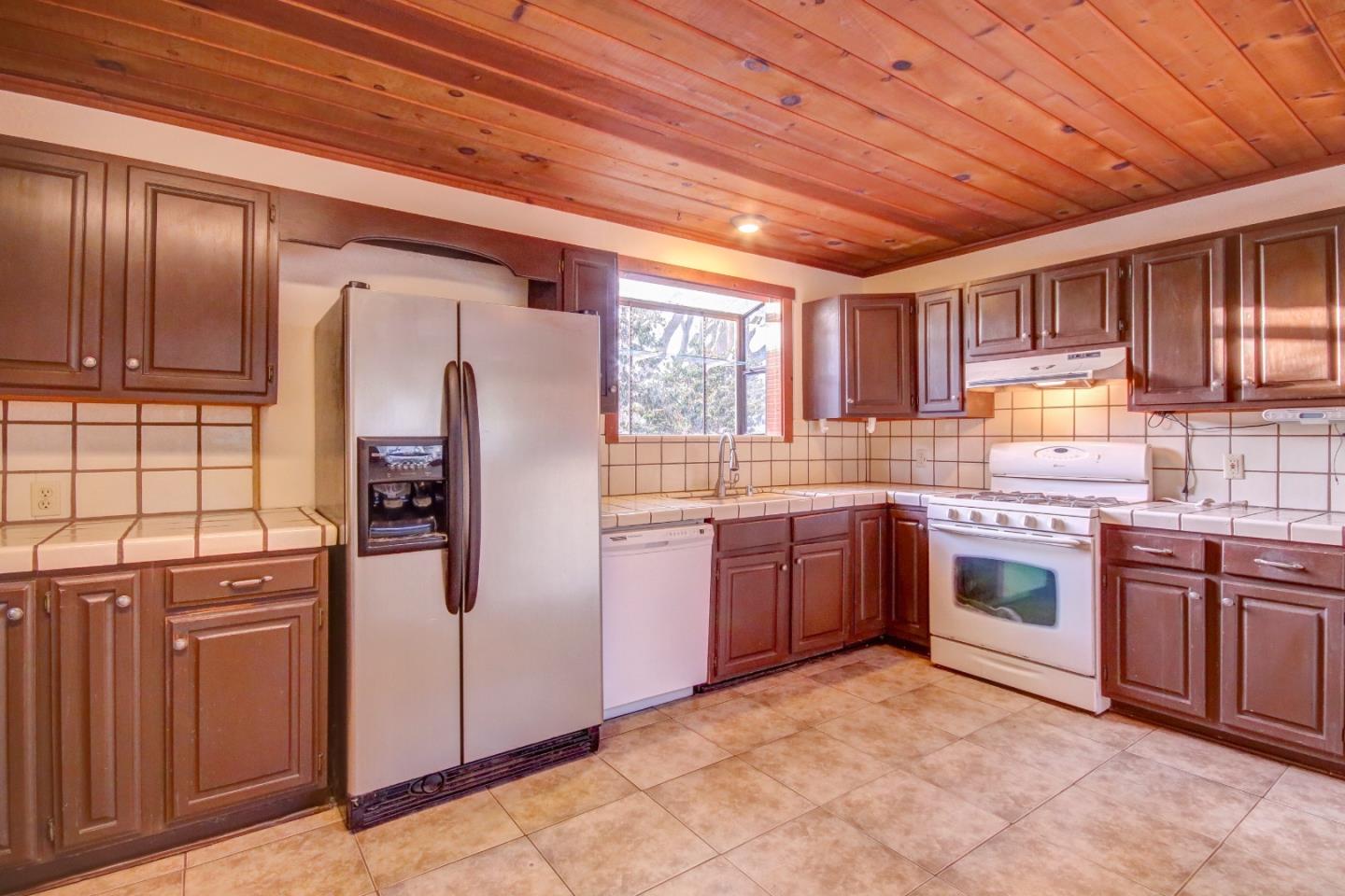 816 Gate Street Pacific Grove, CA 93950 - Photo 7 of 18 a kitchen with stainless steel appliances granite countertop a stove sink and cabinets