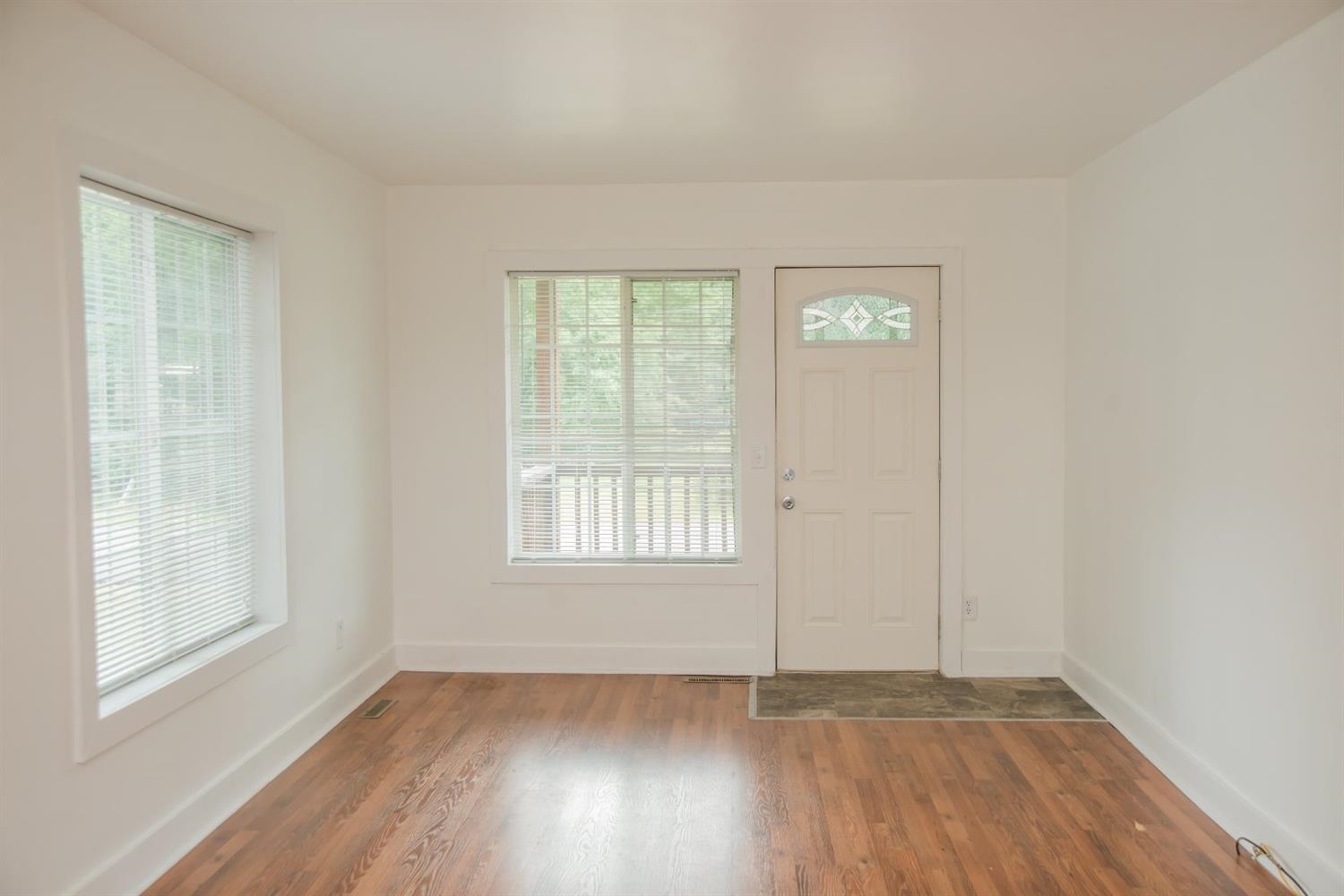 3018 West Old Ridge Road Hobart, IN 46342 - Photo 3 of 10 an empty room with wooden floor and windows