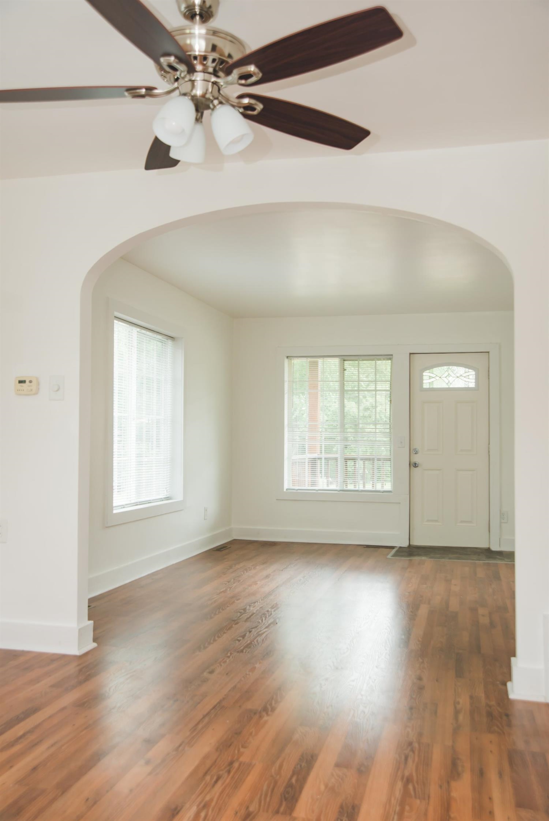 3018 West Old Ridge Road Hobart, IN 46342 - Photo 8 of 10 a view of an empty room with wooden floor and a window