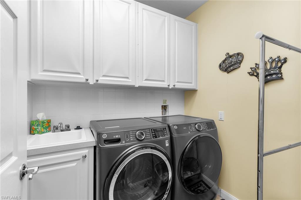 8044 Josefa Way Naples, FL 34114 - Photo 15 of 41 Washroom with washing machine and clothes dryer and cabinet space