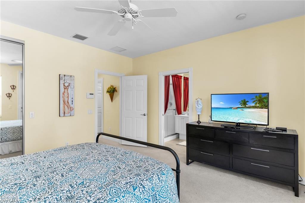 8044 Josefa Way Naples, FL 34114 - Photo 21 of 41 Bedroom featuring light carpet and ceiling fan