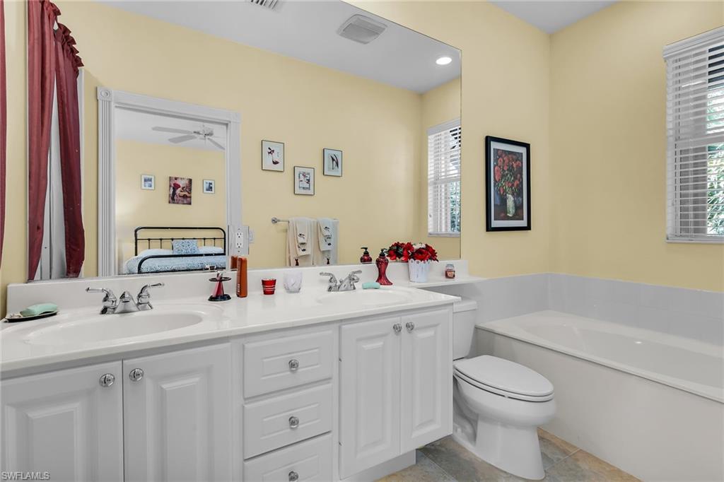 8044 Josefa Way Naples, FL 34114 - Photo 23 of 41 Bathroom featuring double vanity, connected bathroom, a garden tub, recessed lighting, and a ceiling fan