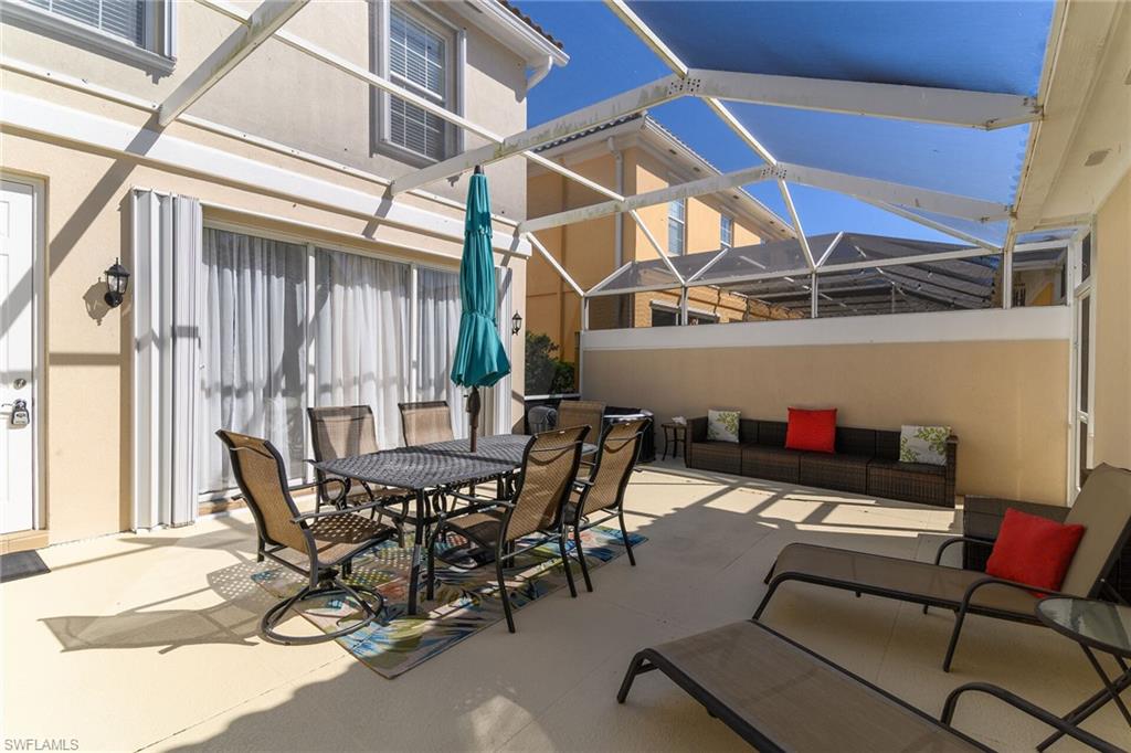 8044 Josefa Way Naples, FL 34114 - Photo 27 of 41 View of patio with a sunroom, glass enclosure, and outdoor dining area