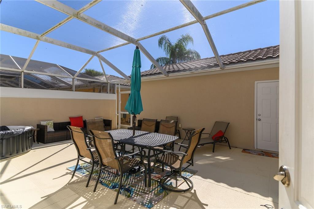 8044 Josefa Way Naples, FL 34114 - Photo 29 of 41 View of patio with outdoor dining area, a sunroom, and a lanai