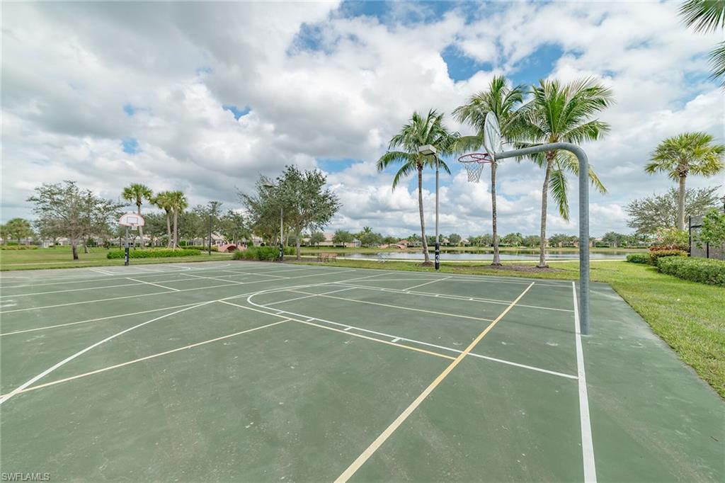 8044 Josefa Way Naples, FL 34114 - Photo 31 of 41 View of basketball court with community basketball court, a water view, and a yard