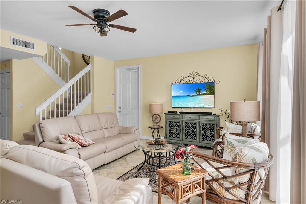 8044 Josefa Way Naples, FL 34114 - Photo 7 of 41 Tiled living area featuring stairway and a ceiling fan