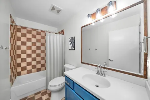 a bathroom with a sink toilet and shower