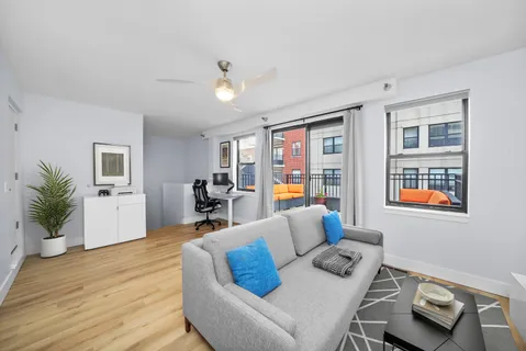 a living room with furniture and wooden floor