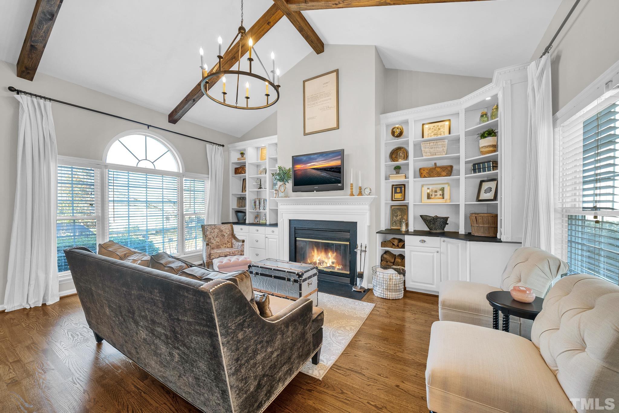 5308 Denmead Way Raleigh, NC 27613 - Photo 13 of 42 a living room with furniture a large window and a fireplace
