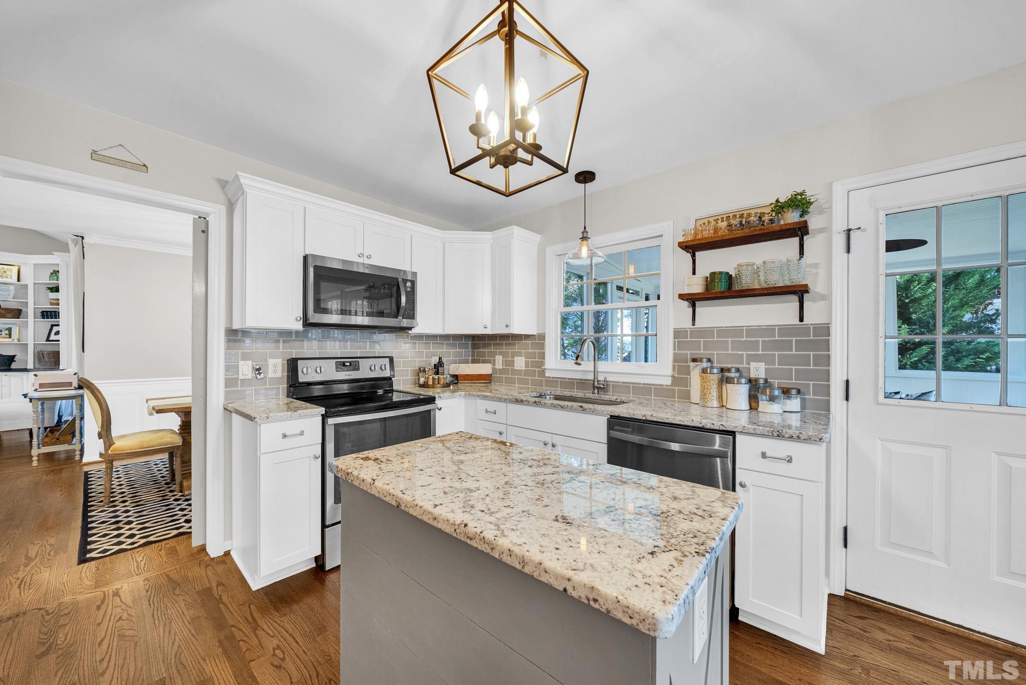 5308 Denmead Way Raleigh, NC 27613 - Photo 19 of 42 a kitchen with stainless steel appliances granite countertop a stove refrigerator and microwave