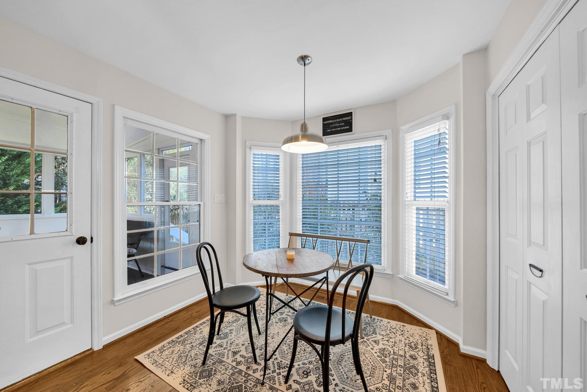 5308 Denmead Way Raleigh, NC 27613 - Photo 24 of 42 a view of a dining room with furniture and wooden floor