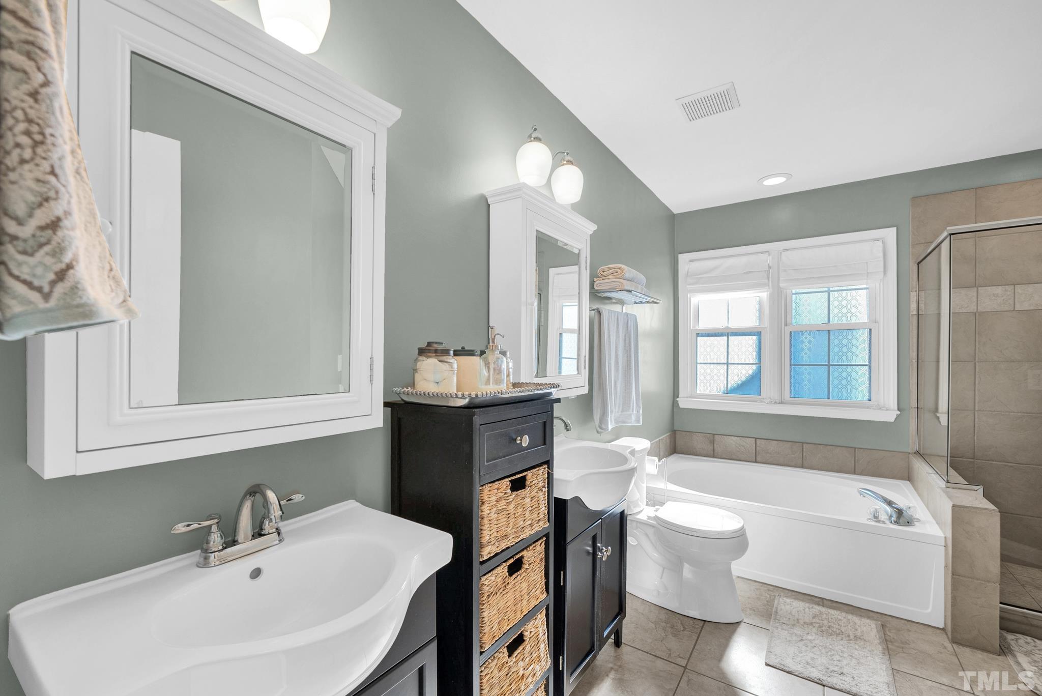 5308 Denmead Way Raleigh, NC 27613 - Photo 29 of 42 a bathroom with a sink a toilet a mirror and bathtub