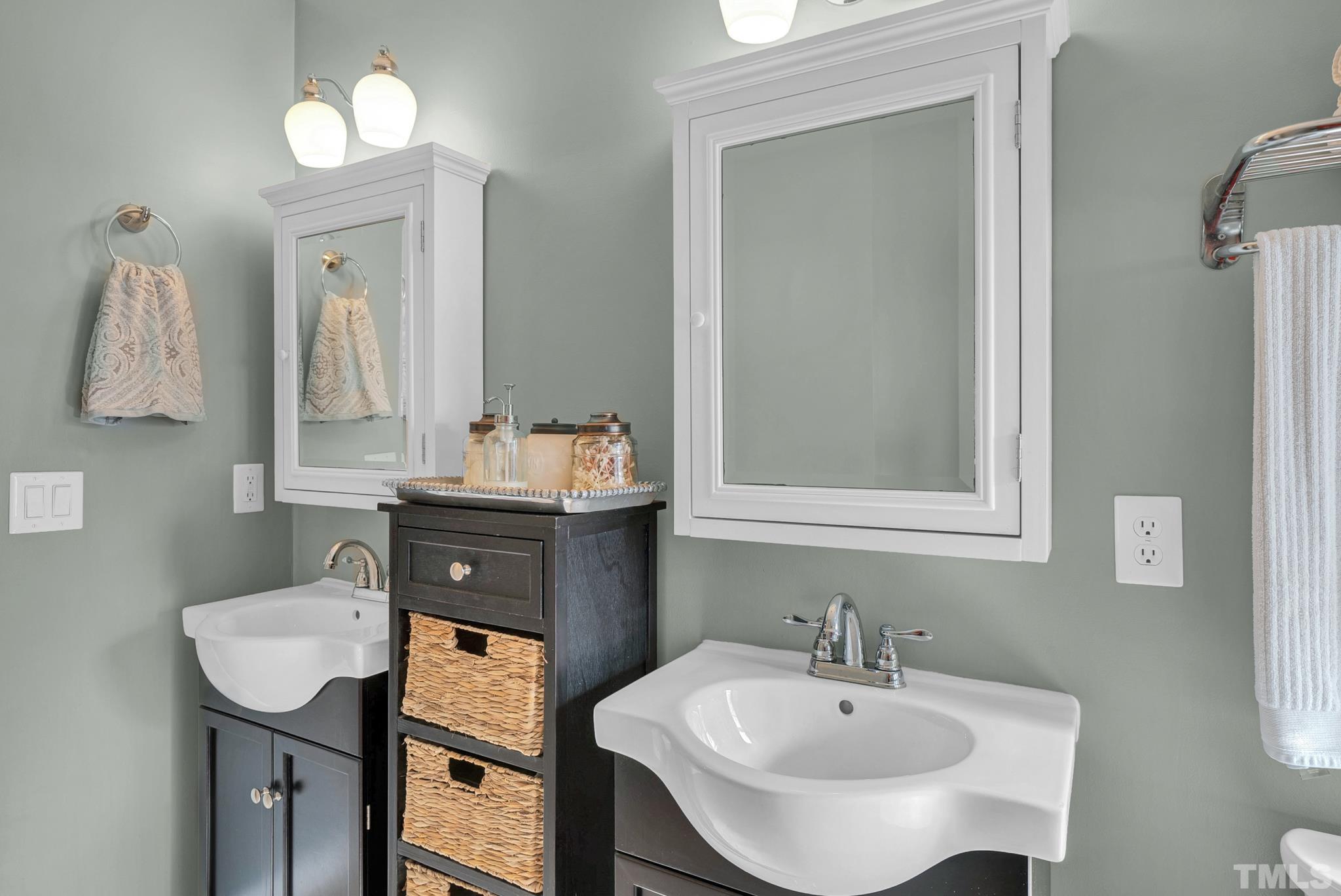 5308 Denmead Way Raleigh, NC 27613 - Photo 31 of 42 a bathroom with a sink and a mirror
