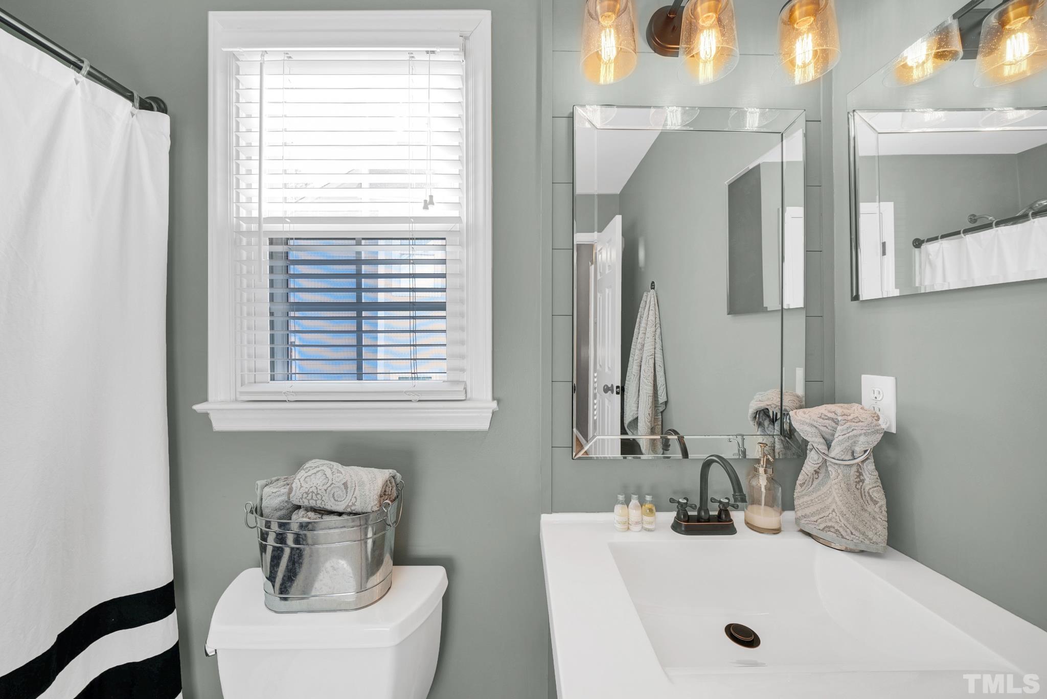 5308 Denmead Way Raleigh, NC 27613 - Photo 35 of 42 a bathroom with a sink and a mirror
