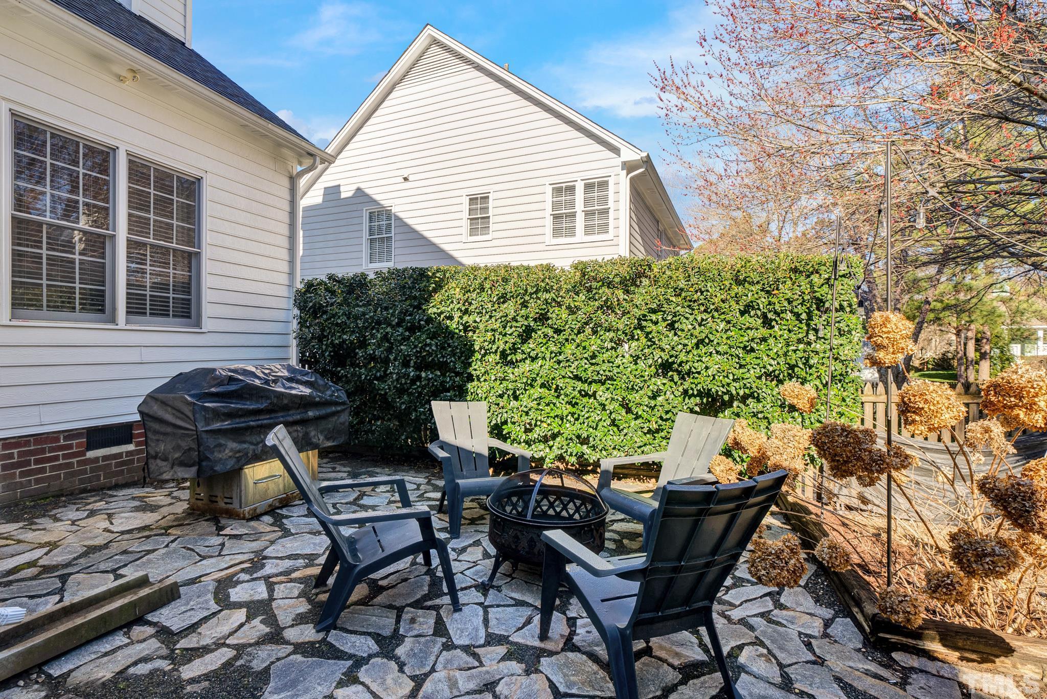 5308 Denmead Way Raleigh, NC 27613 - Photo 37 of 42 a backyard of a house with table and chairs