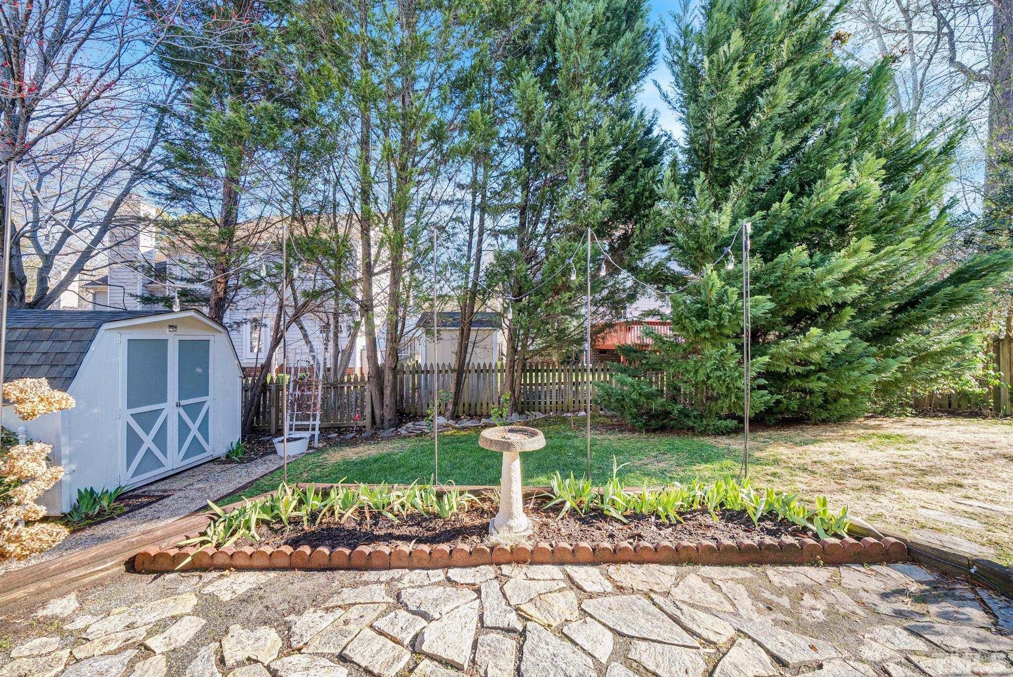 5308 Denmead Way Raleigh, NC 27613 - Photo 38 of 42 a view of a garden with a bench