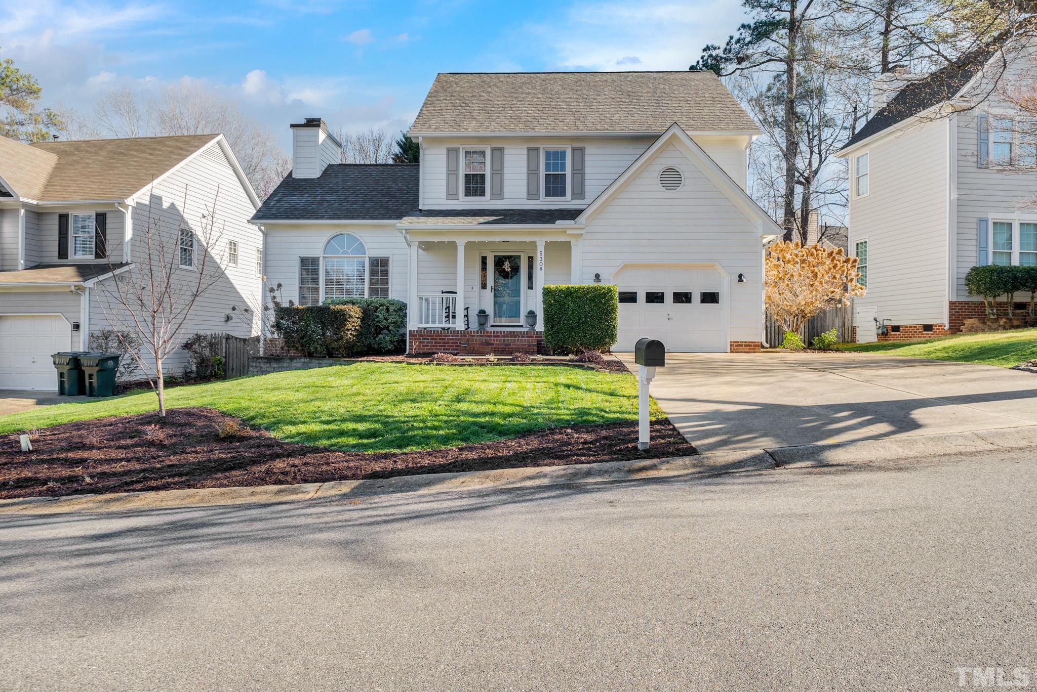 5308 Denmead Way Raleigh, NC 27613 - Photo 41 of 42 a front view of a house with a yard and garage