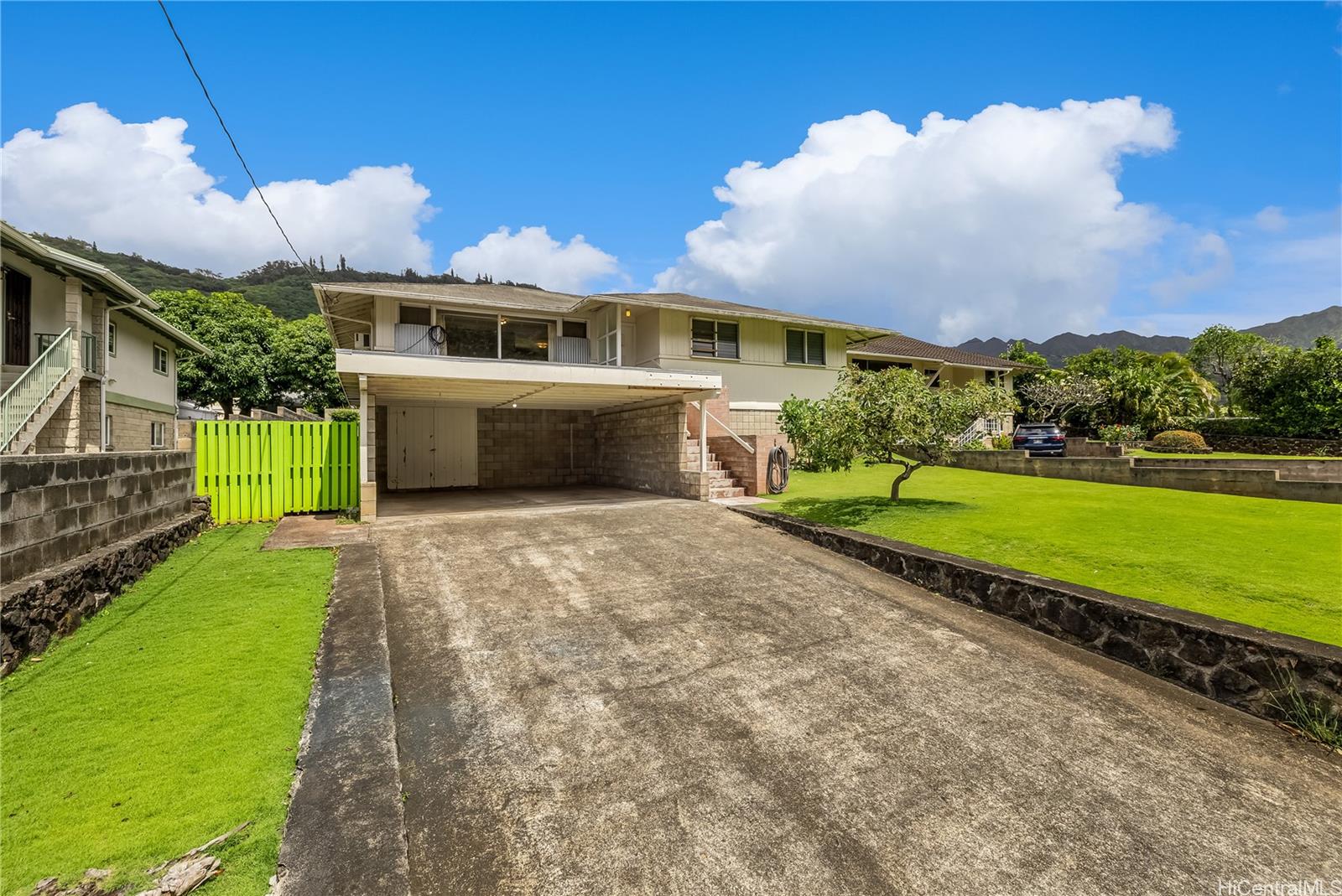 2826 East Manoa Road Honolulu, HI 96822 - Photo 1 of 1 a front view of a house with a garden and a yard