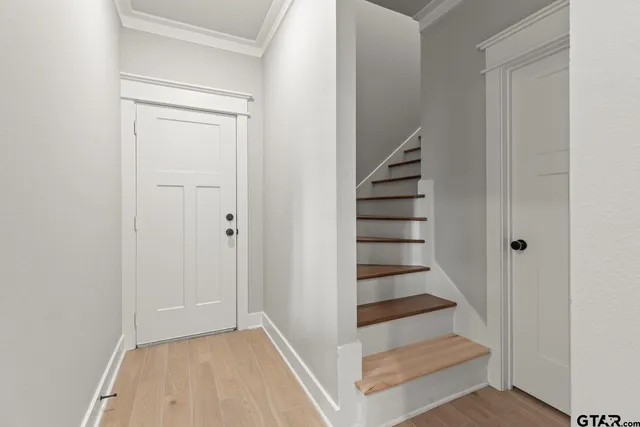 a view of entryway and hall with wooden floor