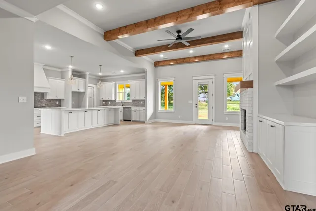a view of a kitchen with a sink and a refrigerator