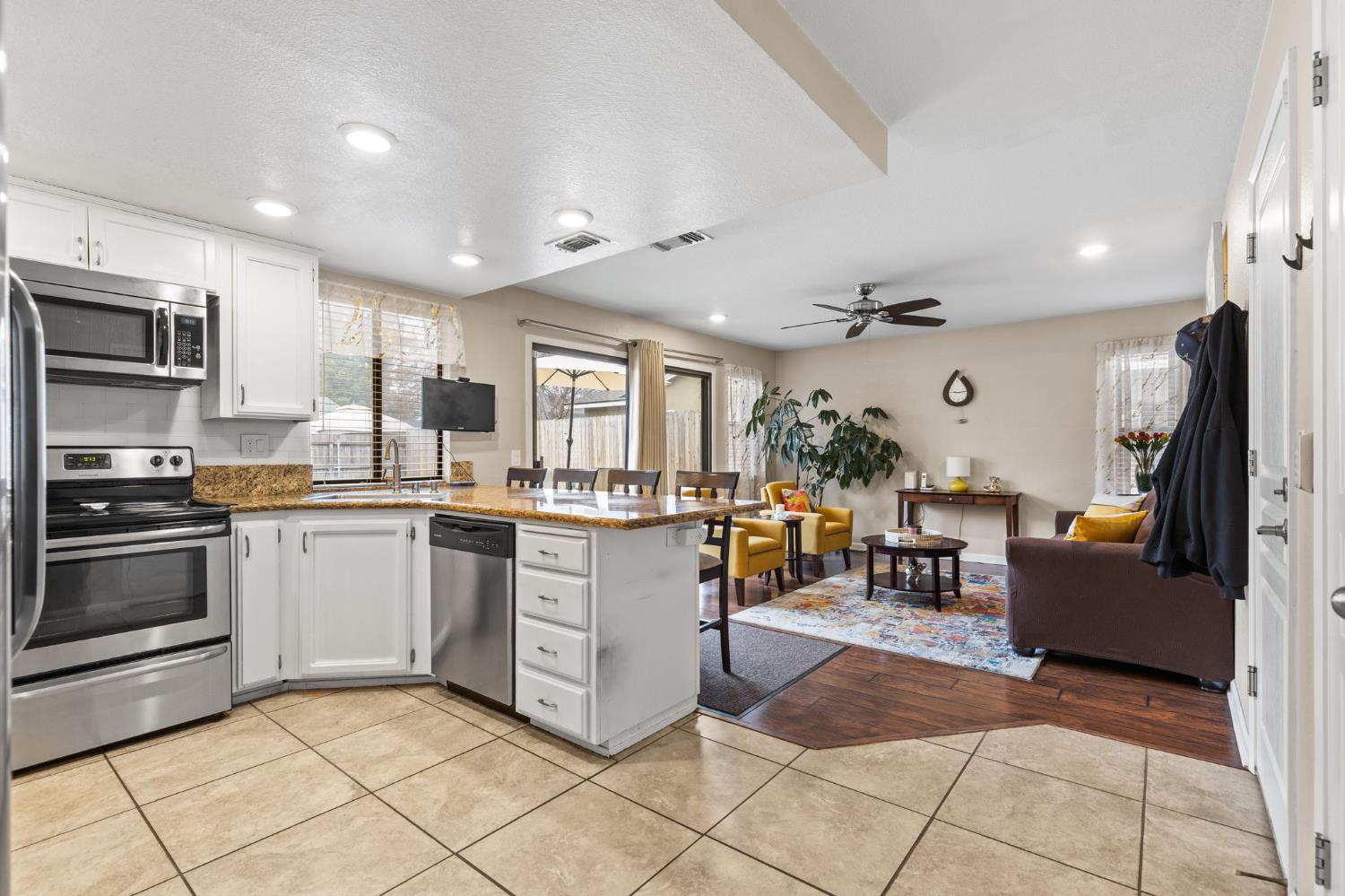 675 Young Way Roseville, CA 95678 - Photo 14 of 35 a kitchen with granite countertop a refrigerator and cabinets