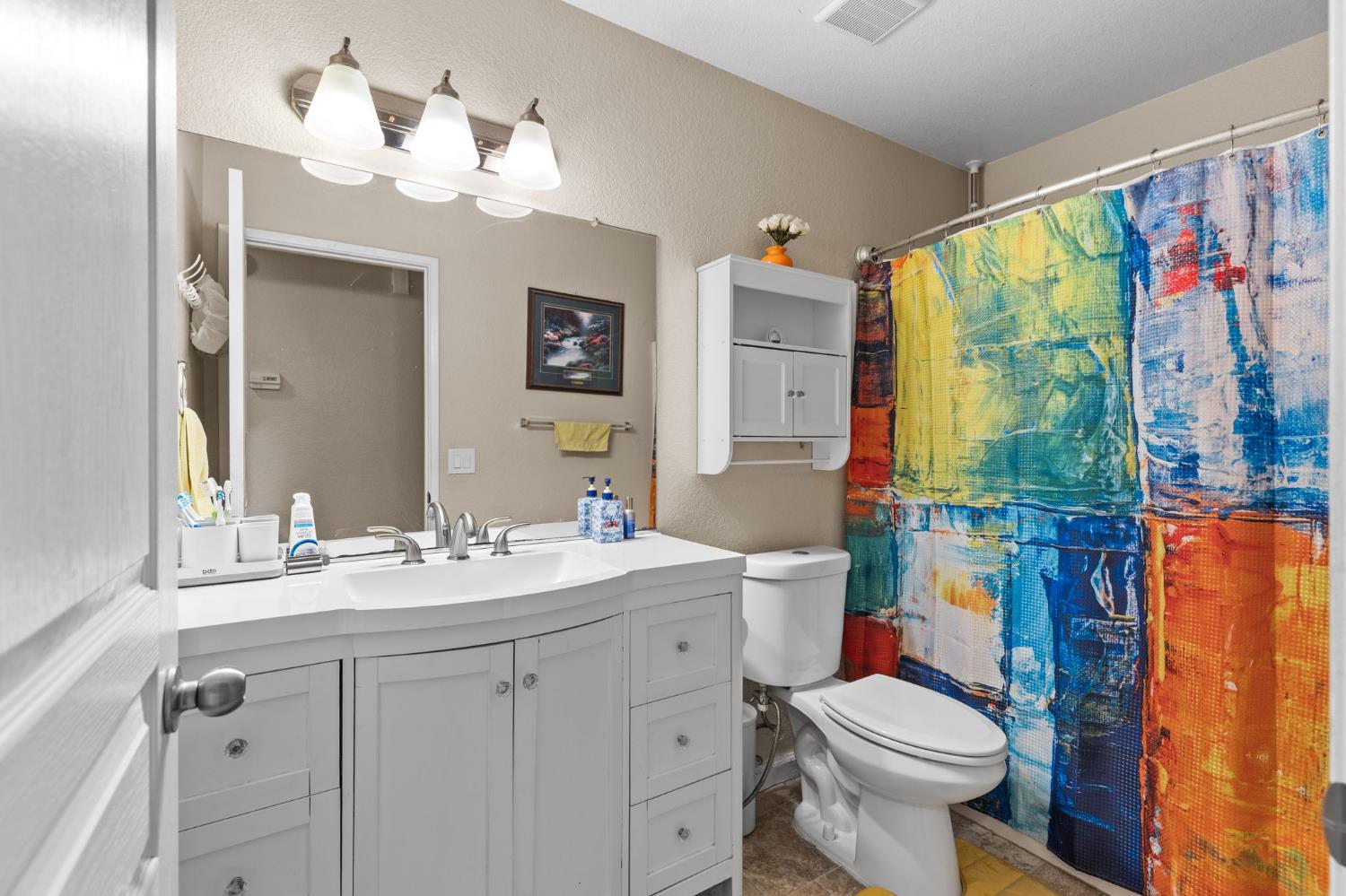 675 Young Way Roseville, CA 95678 - Photo 24 of 35 a bathroom with a sink vanity mirror and toilet