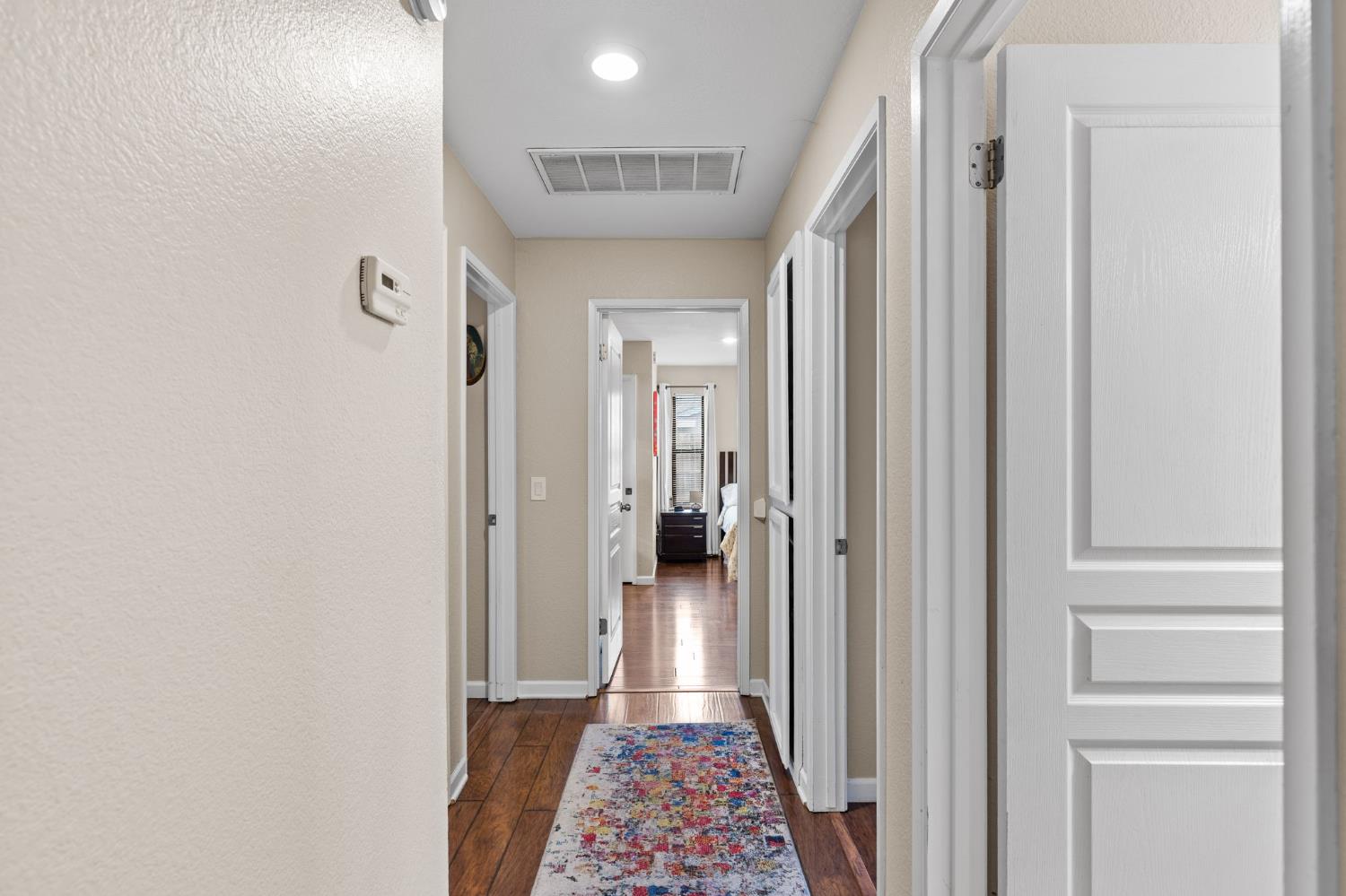 675 Young Way Roseville, CA 95678 - Photo 25 of 35 a view of a hallway with wooden floor and a bathroom