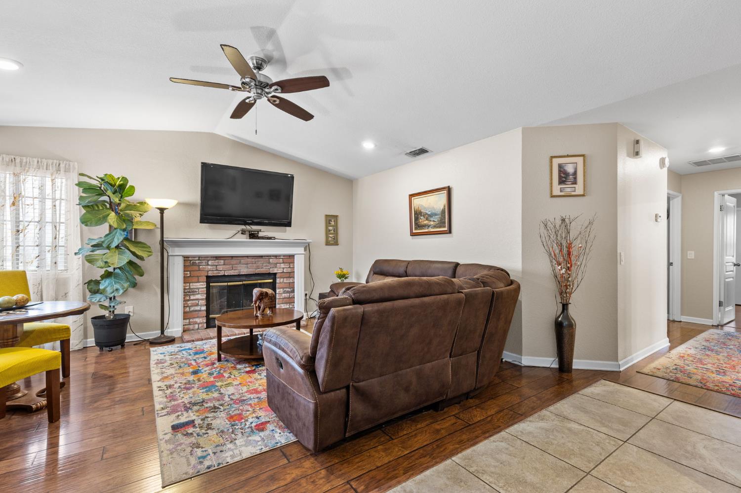 675 Young Way Roseville, CA 95678 - Photo 6 of 35 a living room with furniture a fireplace and a flat screen tv