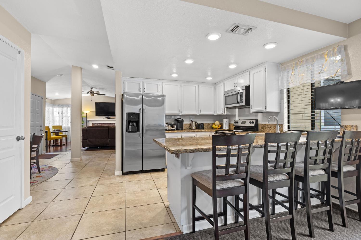 675 Young Way Roseville, CA 95678 - Photo 8 of 35 a kitchen with stainless steel appliances kitchen island granite countertop a refrigerator and cabinets