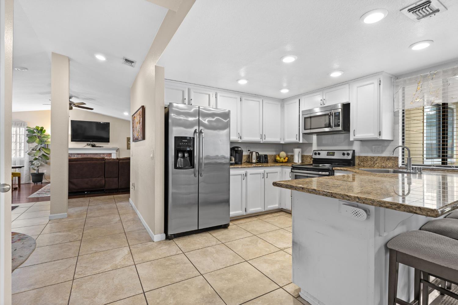 675 Young Way Roseville, CA 95678 - Photo 9 of 35 a kitchen with stainless steel appliances a refrigerator sink microwave and cabinets