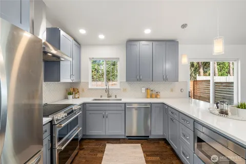 a kitchen with a sink stove and cabinets