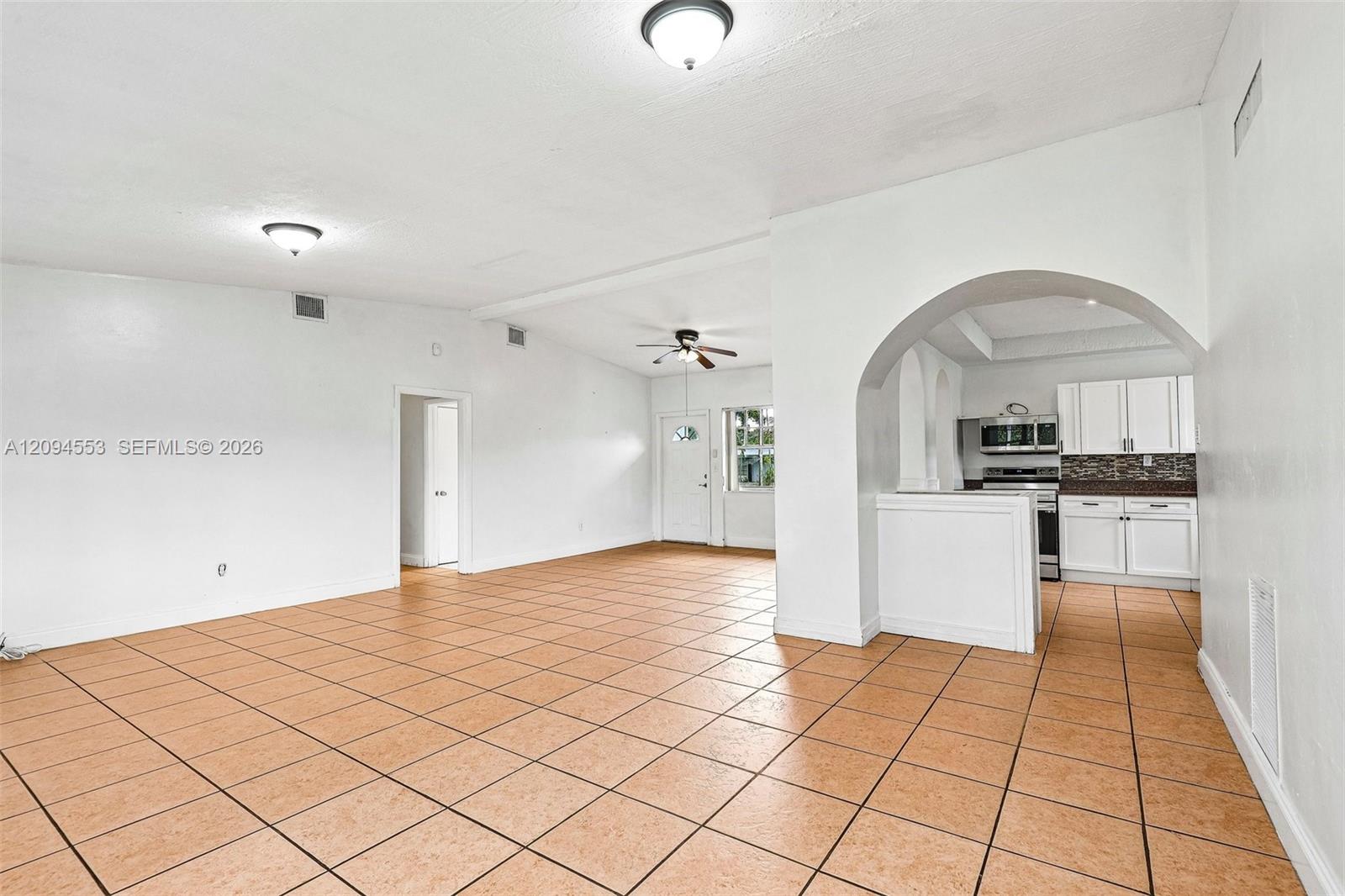 571 Northeast 172nd Street North Miami Beach, FL 33162 - Photo 11 of 33 Open layout from the family room to the kitchen and front door