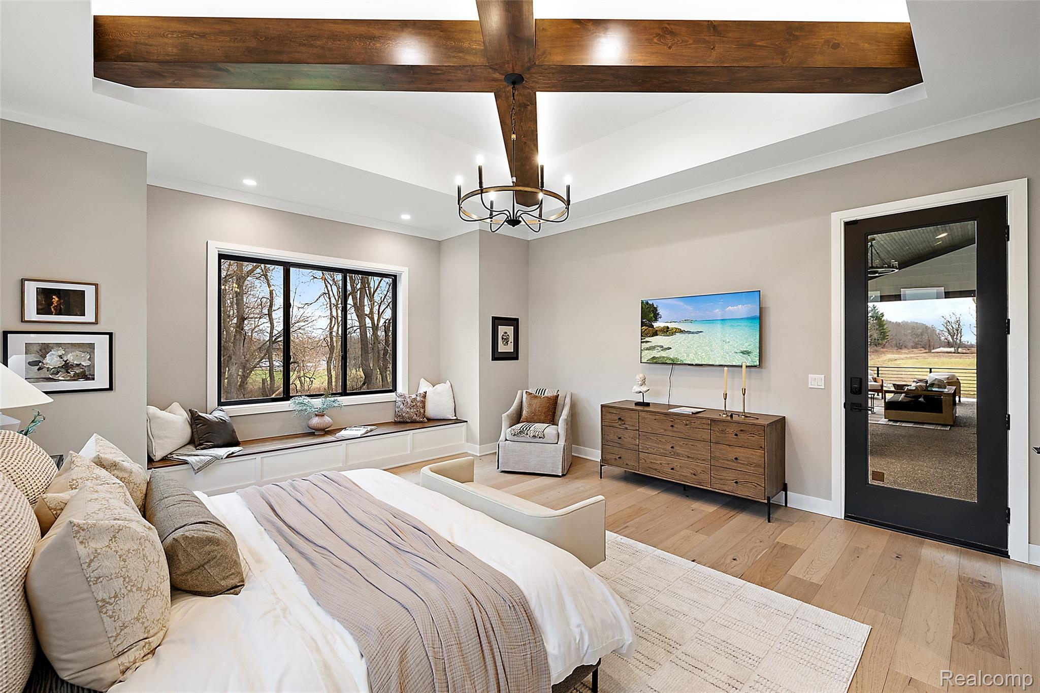 70413 Renata Court Romeo, MI 48065 - Photo 37 of 53 Primary bedroom suite featuring vaulted ceilings with exposed wood beams and recessed lighting, wide-plank wood-finish flooring throughout, and a large multi-pane window overlooking natural landscape