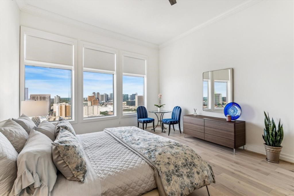3388 Sage Road, Unit 2001 Houston, TX 77056 - Photo 18 of 25 a bedroom with furniture and a large window