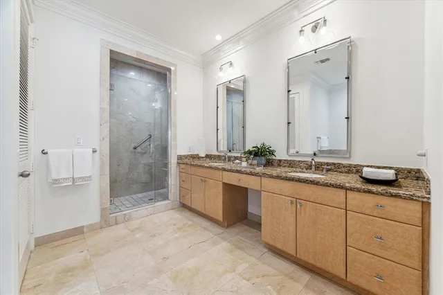 a spacious bathroom with a granite countertop sink mirror and shower